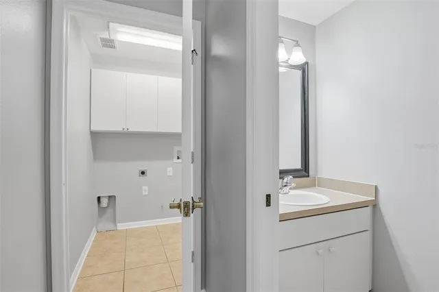a bathroom with a double vanity sink and a mirror