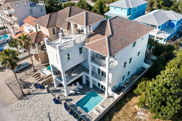 a living room with furniture kitchen view and a chandelier