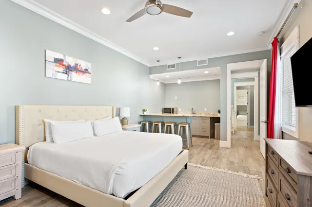 a bedroom with a bed and a flat screen tv