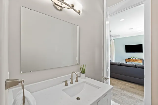 a bathroom with a granite countertop sink and a mirror