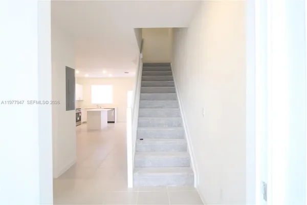 a view of a hallway with stairs