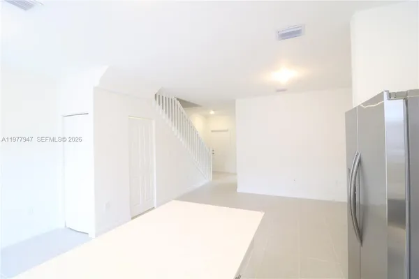 a picture of a room with a refrigerator