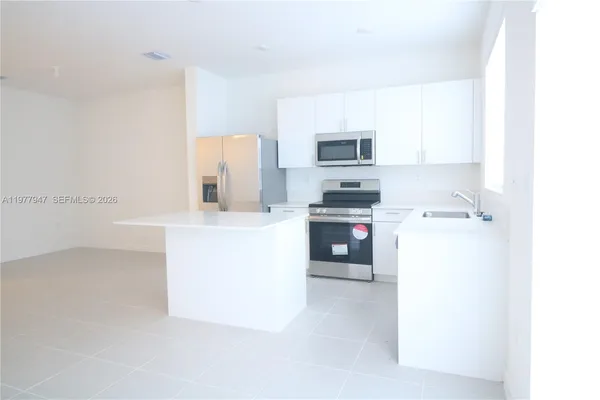 a utility room with cabinets washer and dryer