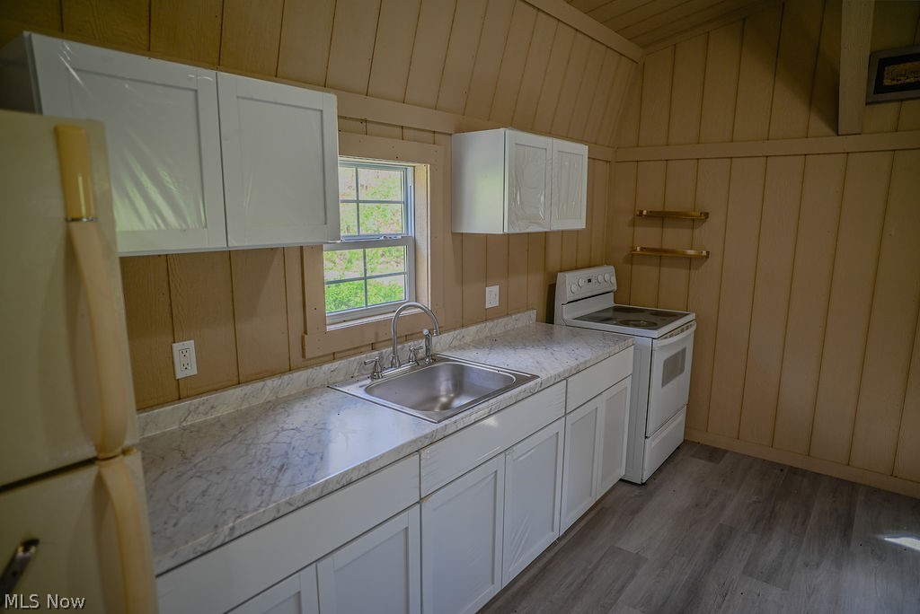 1547 Providence Road Elizabeth, WV 26143 - Photo 7 of 32 Functional kitchen area featuring white cabinetry, a stainless steel sink, a window, and wood-finish flooring