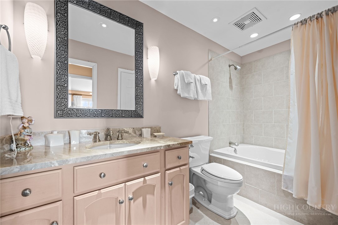 331 Alpine Road Blowing Rock, NC 28605 - Photo 32 of 50 a bathroom with a granite countertop sink a toilet and a bathtub