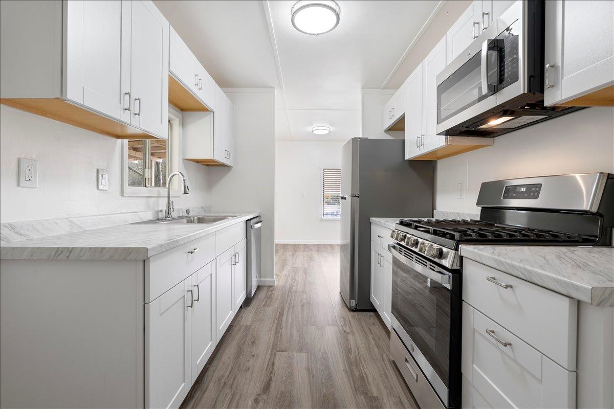 1525 Cold Springs Road, Unit 37 Placerville, CA 95667 - Photo 2 of 37 a kitchen with stainless steel appliances granite countertop a stove a sink and a refrigerator