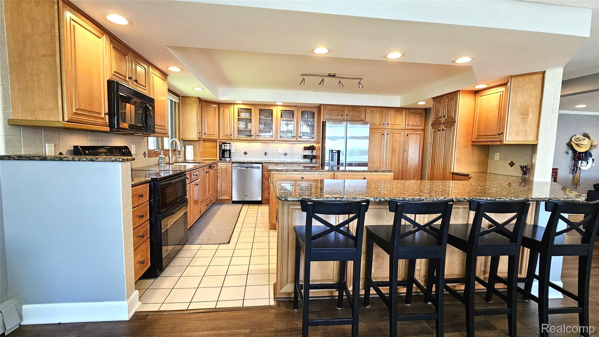 10202 Buhl Road Pinckney, MI 48169 - Photo 4 of 19 Kitchen featuring light wood cabinetry, granite countertops, recessed lighting, stainless steel appliances, and tile flooring