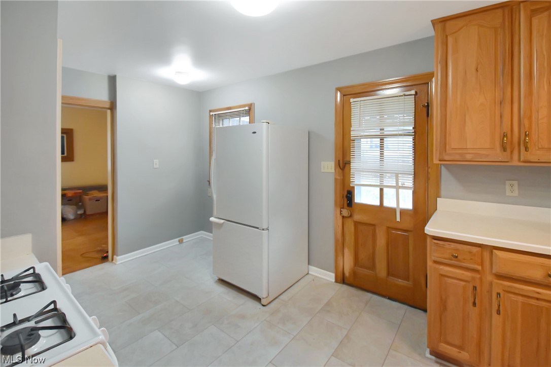 1068 Rushleigh Road Cleveland Heights, OH 44121 - Photo 11 of 22 Kitchen with light tile flooring and white refrigerator