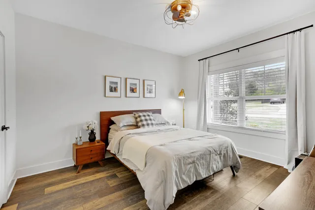 a bathroom with a granite countertop sink mirror vanity and toilet