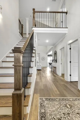 a spacious bedroom with a bed and a chandelier