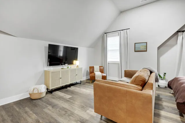 a view of a yard in front of a house with large trees