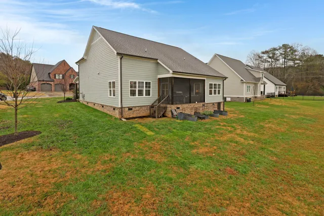 a view of a house with a yard and sitting area