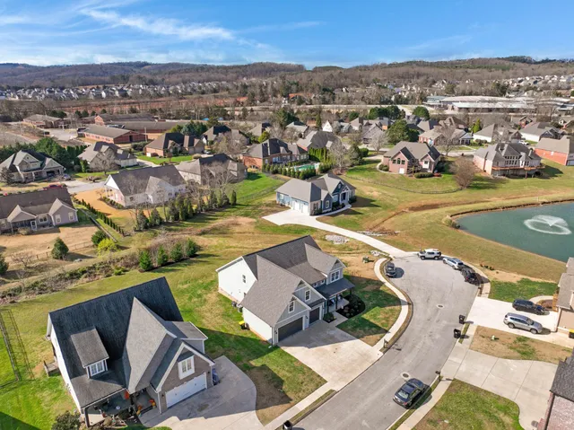 an aerial view of a house with a yard and trees