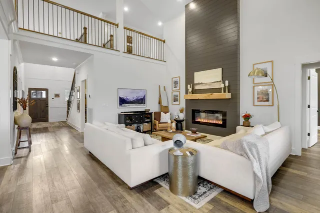 a living room with furniture a flat screen tv and a fireplace