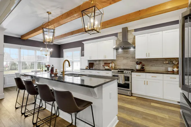 a kitchen with stainless steel appliances granite countertop a sink and cabinets