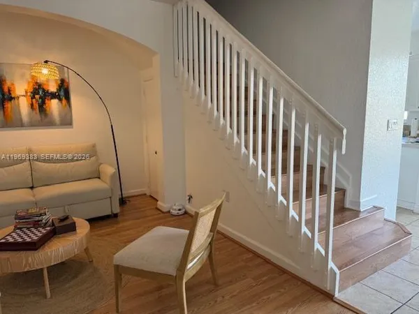 a view of a livingroom with furniture and staircase