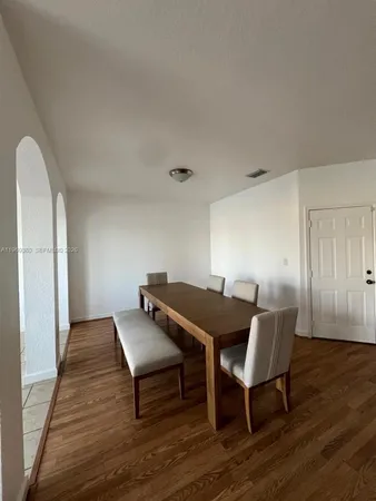 a view of a workspace with furniture and wooden floor