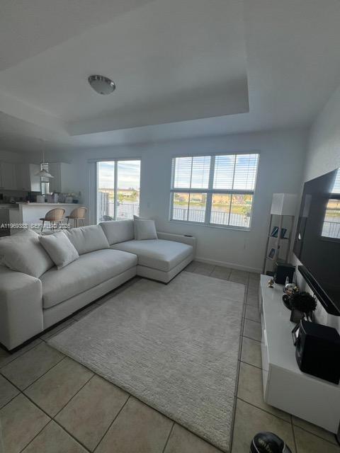 15243 Southwest 9th Way Miami, FL 33194 - Photo 5 of 14 a living room with furniture and a flat screen tv
