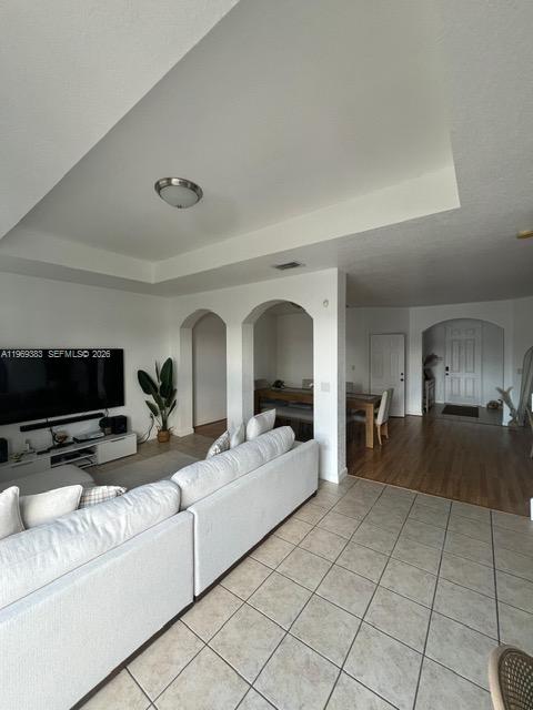 15243 Southwest 9th Way Miami, FL 33194 - Photo 6 of 14 a living room with furniture and a flat screen tv