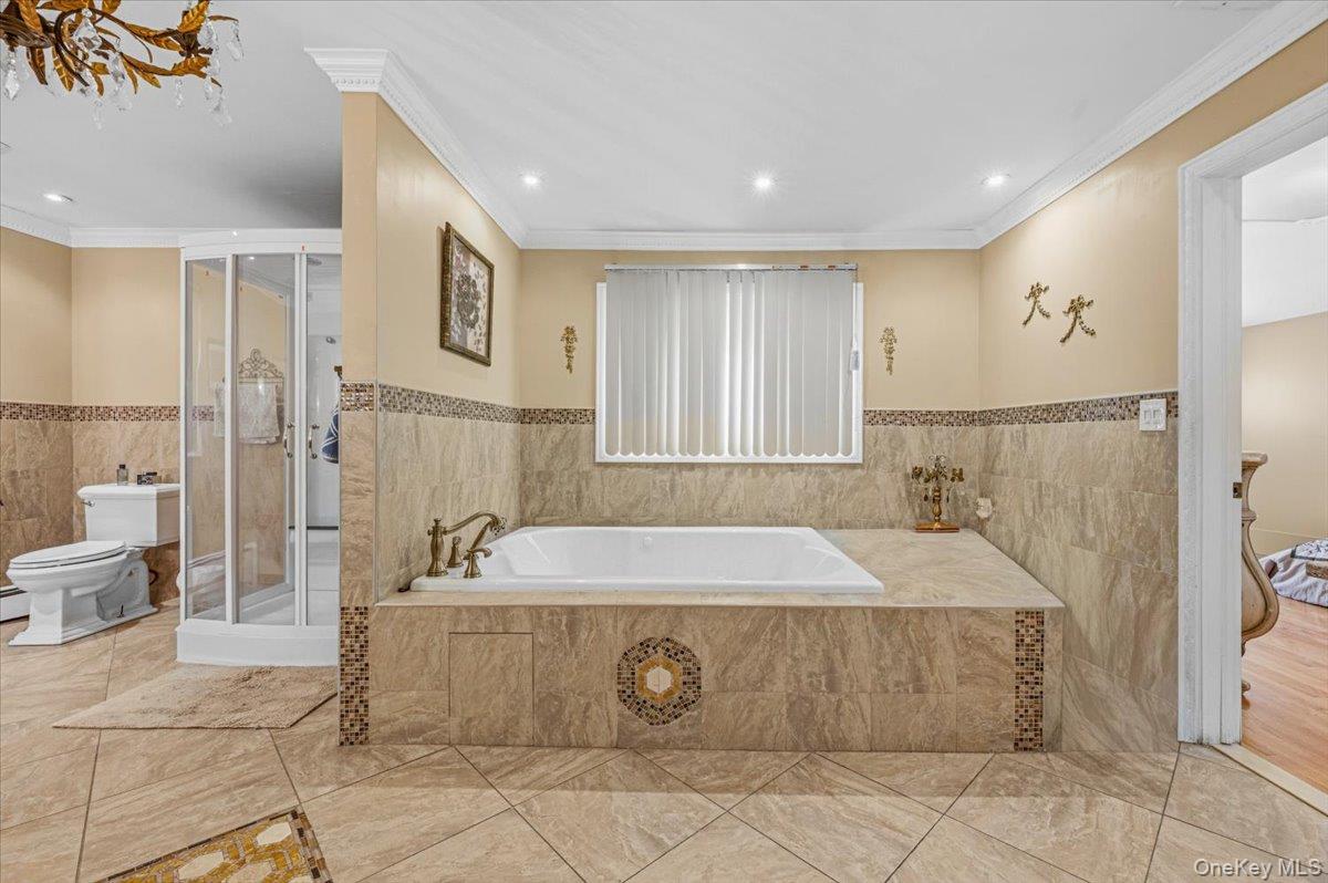 626 Caledonia Road Dix Hills, NY 11746 - Photo 32 of 49 a spacious bathroom with a tub sink and mirror