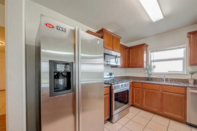 a kitchen with a sink counter top space and stainless steel appliances