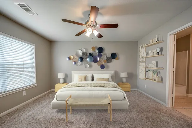 a bedroom with a large bed and a chandelier