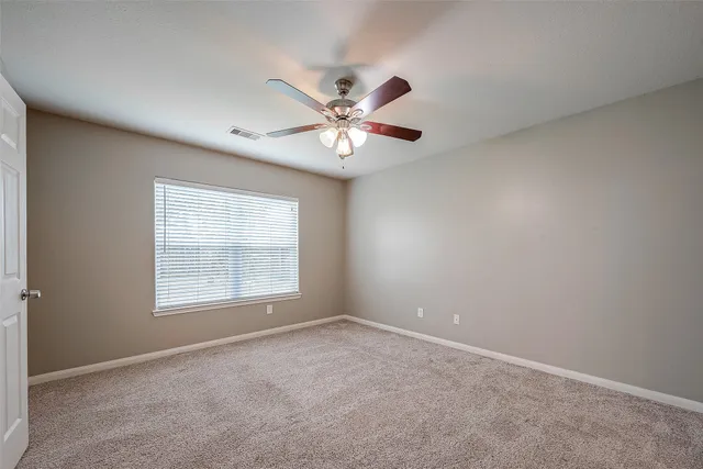 a view of a big room with closet and a chandelier fan
