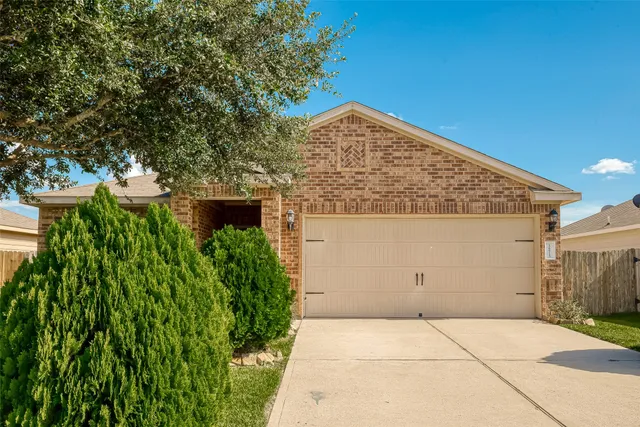 a front view of a house with plants