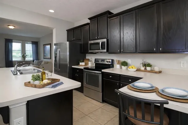a kitchen with a sink and steel appliances