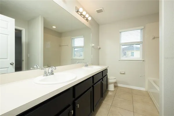 a bathroom with a sink double vanity and a mirror