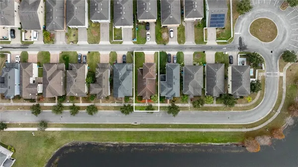 an aerial view of residential house with outdoor space and parking