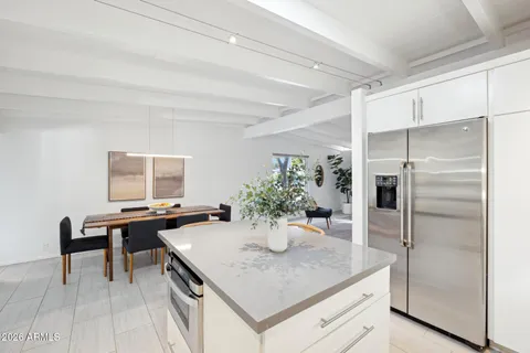 a kitchen with granite countertop a sink a stove cabinets and counter space
