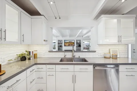 a kitchen with a stove and a wooden cabinets