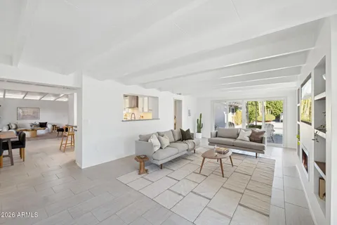 a living room with furniture large window and flat screen tv