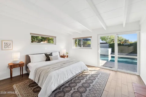 a bedroom with a bed and a lamp