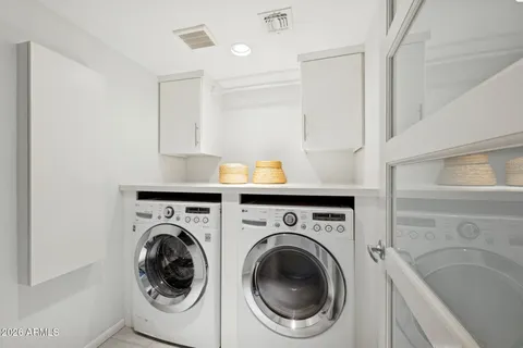 a view of a patio with a table and chairs under a large umbrella