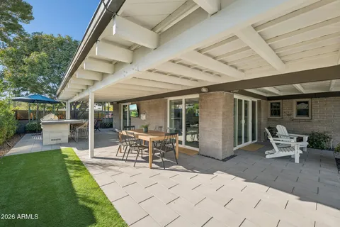 a view of a patio with table and chairs and potted plants