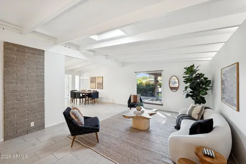 a living room with furniture a table and a potted plant