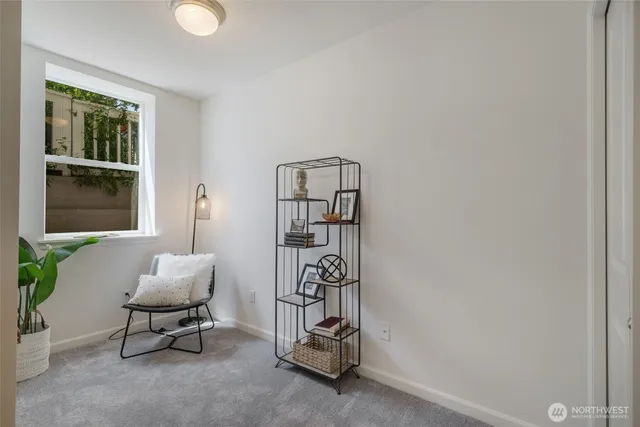 a living room with furniture a window and a potted plant