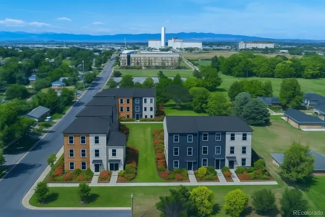 a view of a house with a yard and potted plants