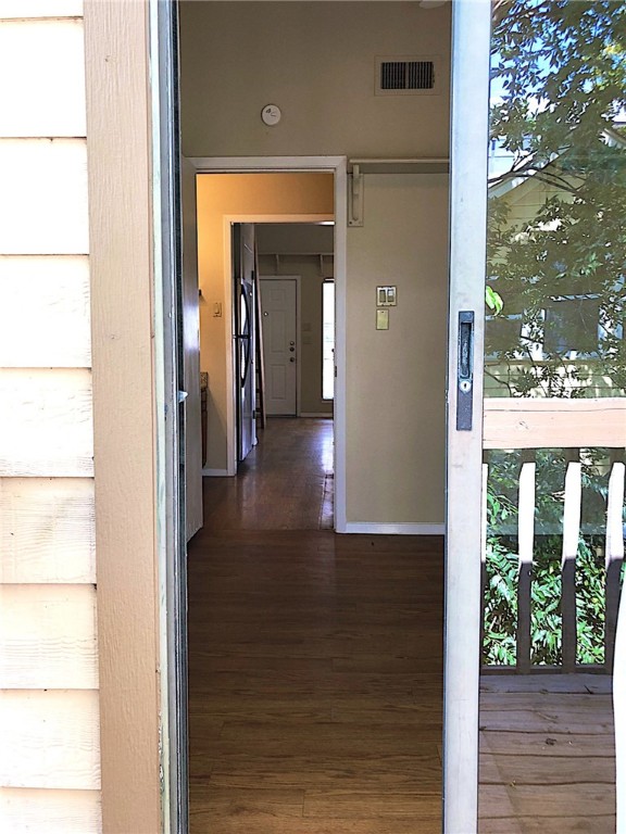 2210 Pearl Street, Unit 304 Austin, TX 78705 - Photo 27 of 32 a view of a hallway with wooden floor and a floor to ceiling window