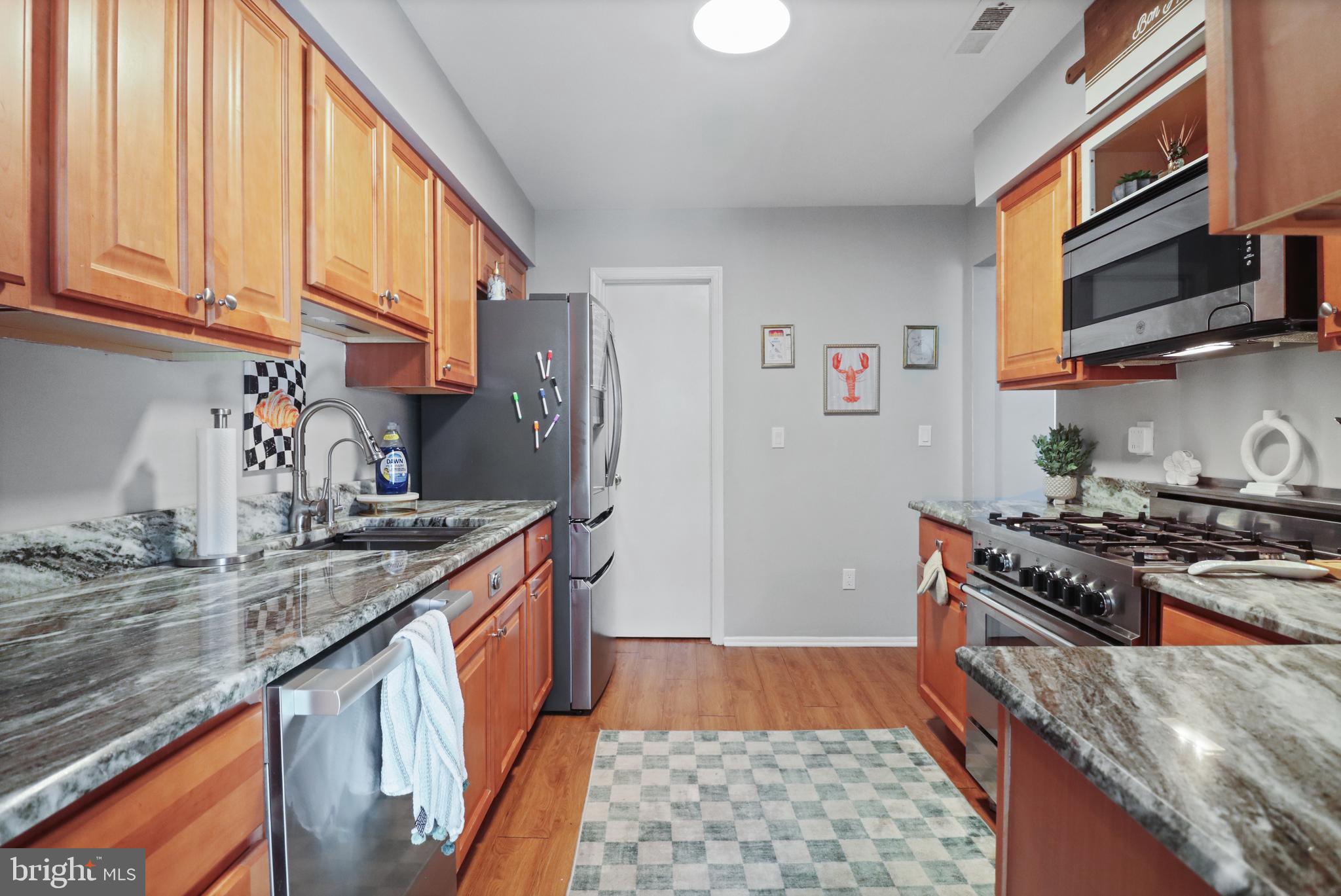 8 Bayleaf Drive Lumberton, NJ 08048 - Photo 19 of 53 a kitchen with stainless steel appliances granite countertop a stove a sink and a microwave