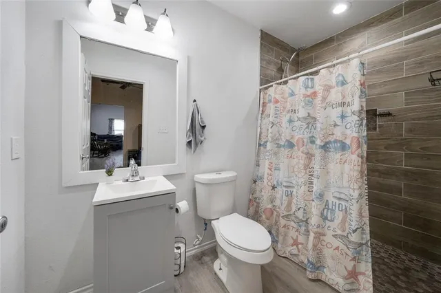 a bathroom with a toilet sink and shower