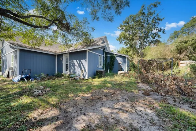 a backyard of a house with plants and outdoor seating