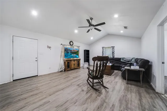 a view of a workspace with furniture and wooden floor