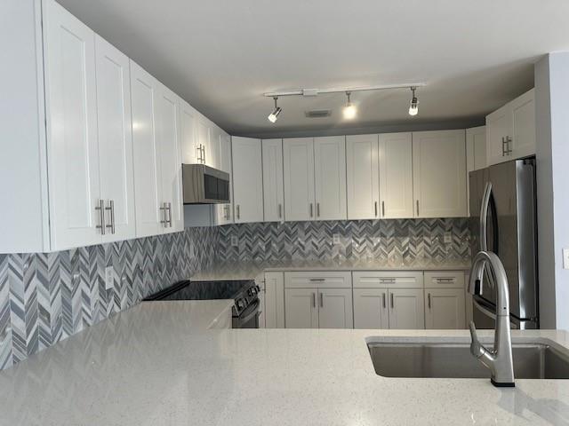 4151 Eastridge Circle Deerfield Beach, FL 33064 - Photo 2 of 53 a kitchen with stainless steel appliances granite countertop a sink a stove and a refrigerator