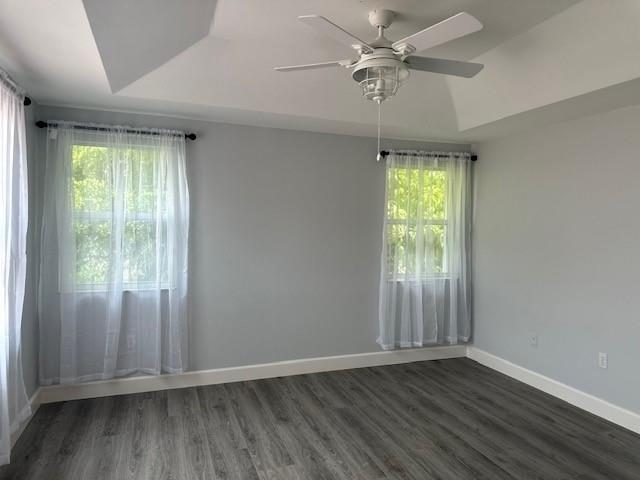 4151 Eastridge Circle Deerfield Beach, FL 33064 - Photo 23 of 53 an empty room with wooden floor fan and windows