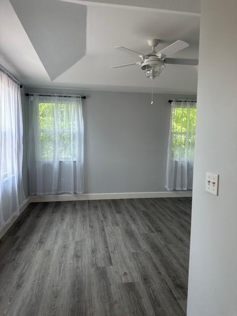 4151 Eastridge Circle Deerfield Beach, FL 33064 - Photo 25 of 53 an empty room with wooden floor fan and windows