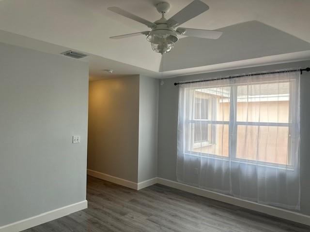 4151 Eastridge Circle Deerfield Beach, FL 33064 - Photo 28 of 53 an empty room with wooden floor and windows
