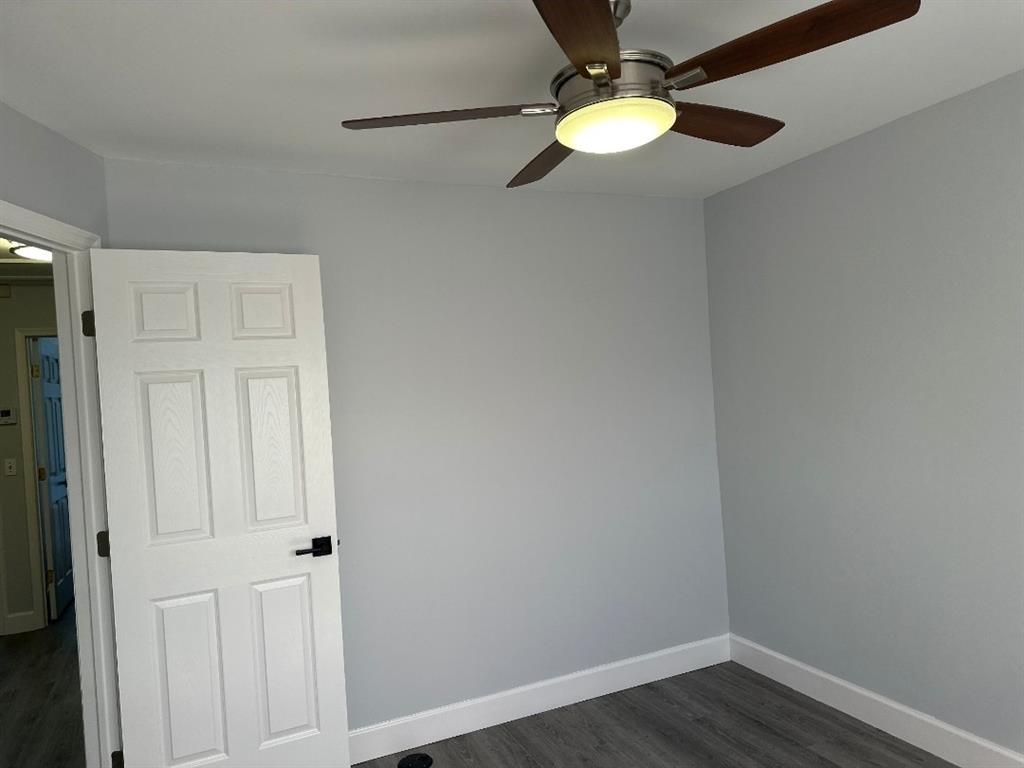 4151 Eastridge Circle Deerfield Beach, FL 33064 - Photo 37 of 53 a view of a small space with wooden floor a chandelier fan and closet